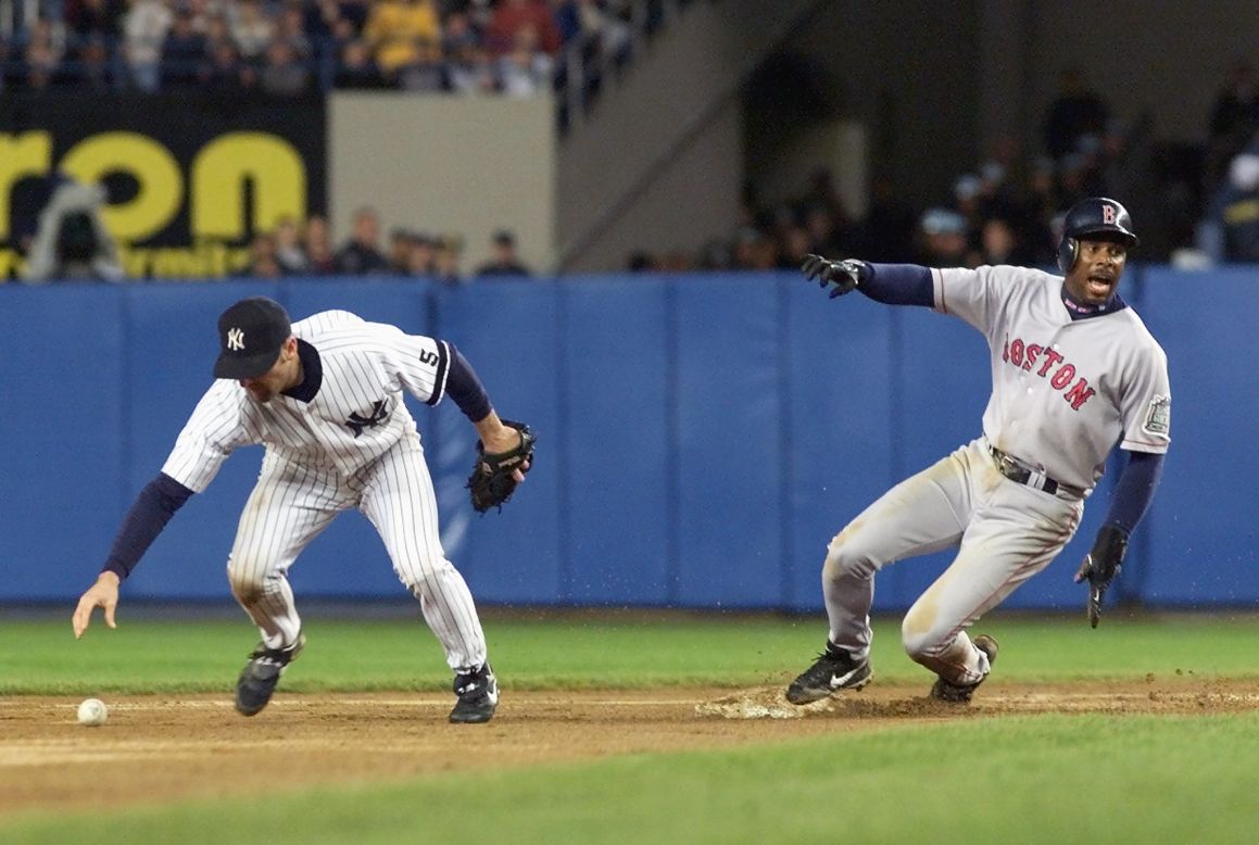 New York Yankees' Chuck Knoblauch slides into home scoring the