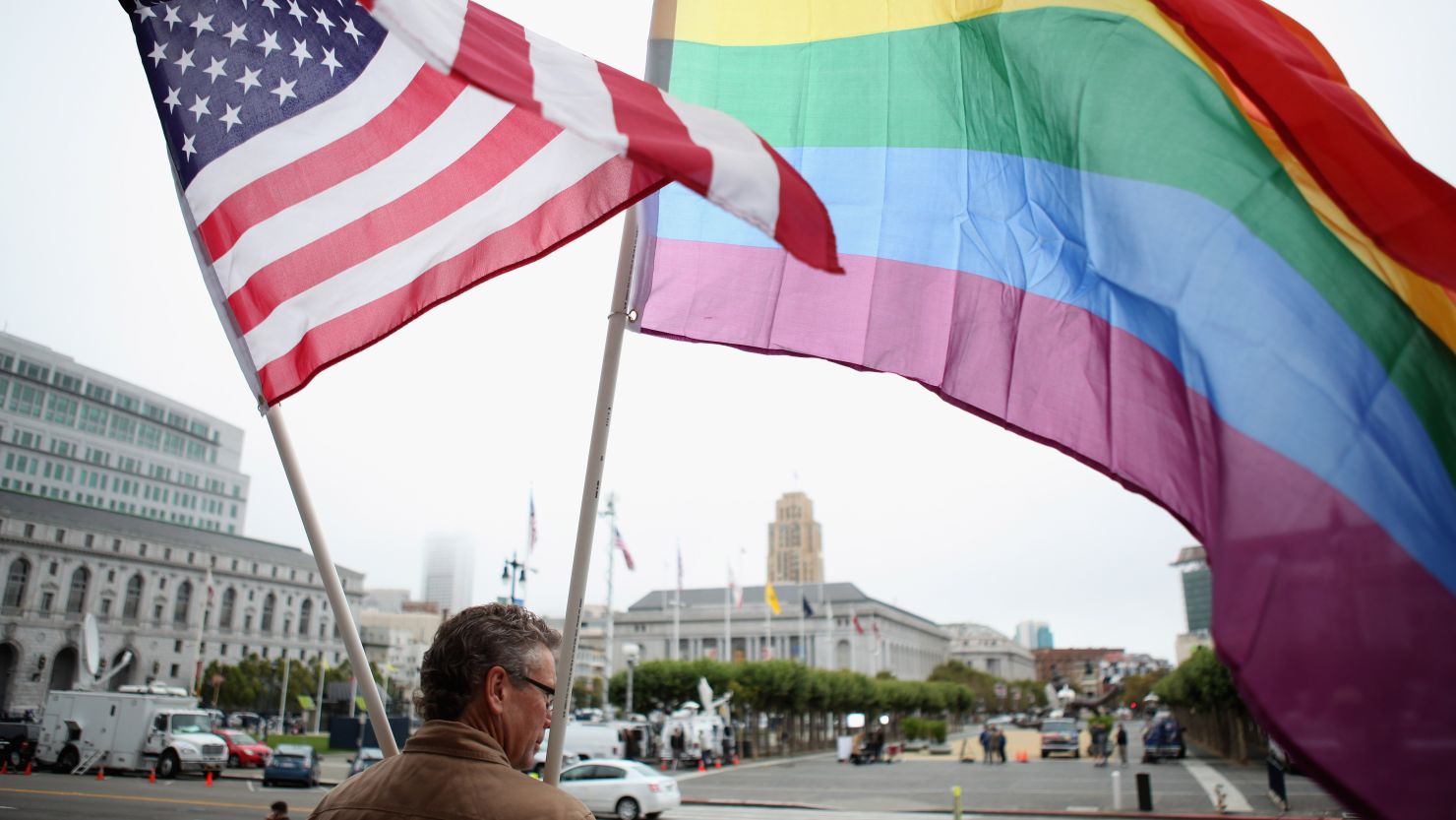 A demonstrator waves American and gay pride flags in San Francisco in 2010. California law bans same-sex marriage.
