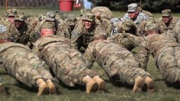 Afghanistan-bound soldiers do pushups following a departure ceremony on November 4, 2011 in Fort Carson, Colorado. 