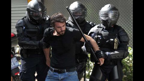 Police arrest a demonstrator during the protest march on Wednesday.