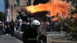 Firebombs explode in front of riot police on September 26, 2012 in Athens during clashes with demonstrators at a 24-hours general strike. Police in Athens clashed with hooded youths throwing firebombs on the sidelines of a large demonstration against a new round of austerity cuts.    AFP PHOTO / ARIS MESSINIS        (Photo credit should read ARIS MESSINIS/AFP/GettyImages)
