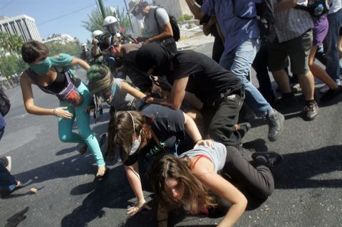 Protesters fall down in the street during clashes on Wednesday.