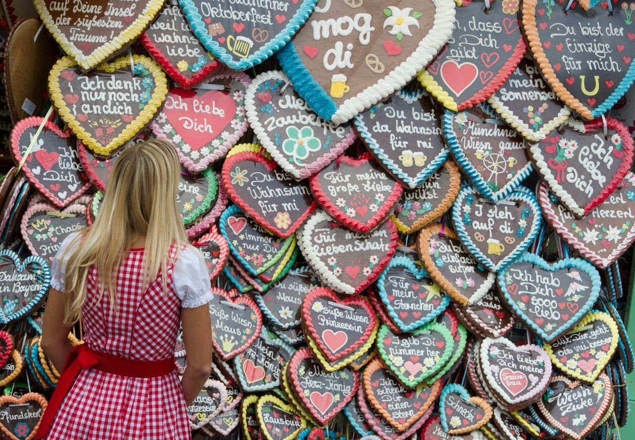 A woman stands in front of gingerbread hearts on Wednesday, September 26, the fifth day of the festival.