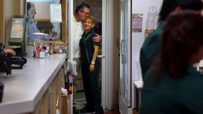 Former Florida Gov. Jeb Bush hugs a waitress as they wait for Ryan's arrival during a campaign stop at a restaurant in Miami's Little Havana neighborhood on Saturday, September 22.