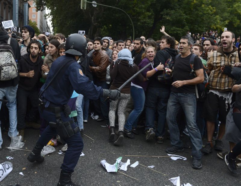 Protesters clash with riot police Tuesday in Madrid. At one point, police charged demonstrators with batons to prevent them from approaching Parliament, which was in session.