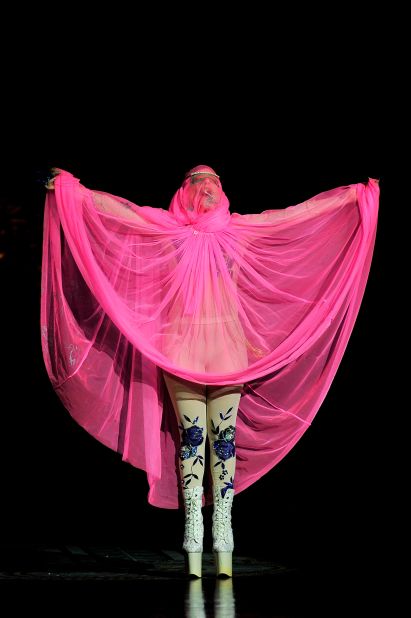 Lady Gaga drapes herself in pink on the catwalk at the Philip Treacy fashion show in 2012.