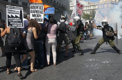 Protesters clash with riot police during the general strike demonstration in Athens on Wednesday.