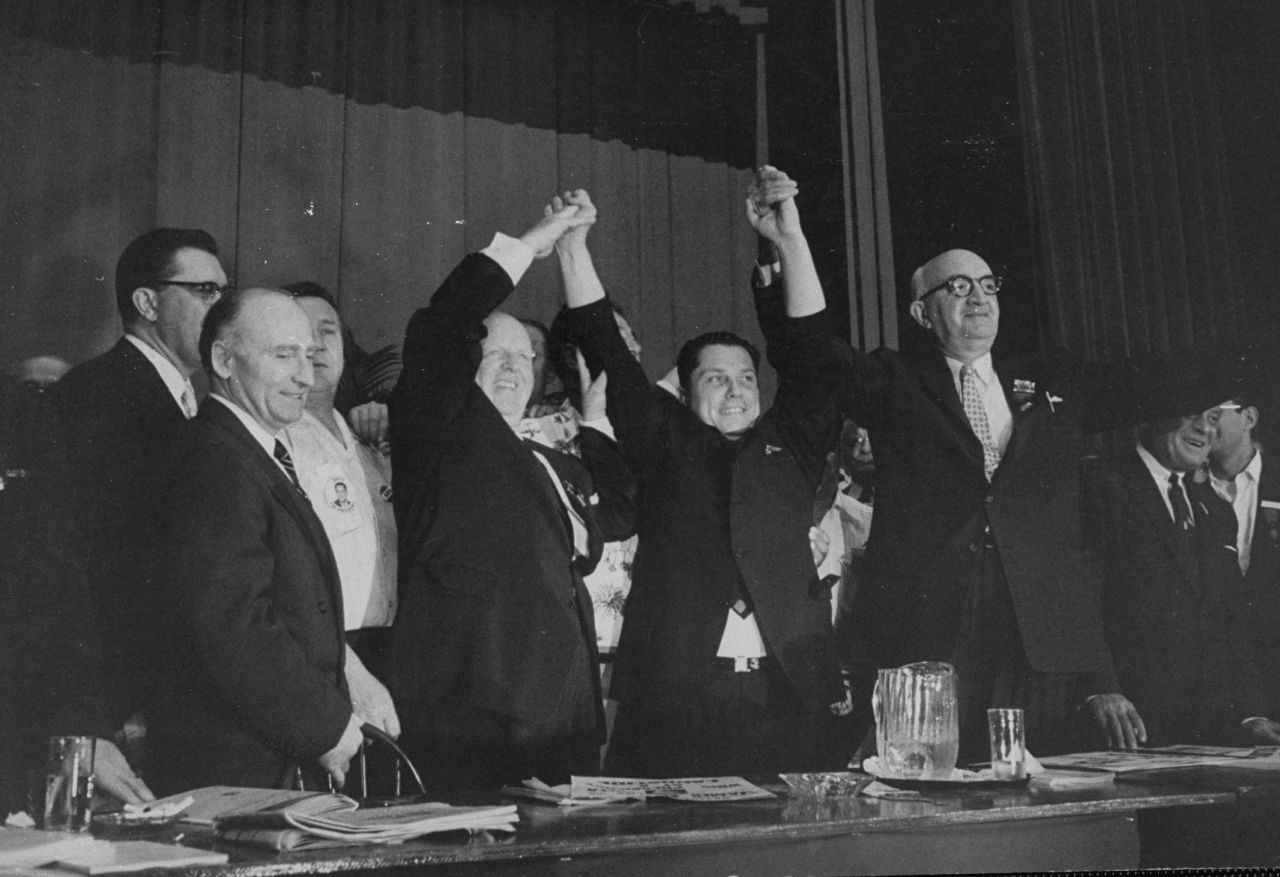 Hoffa, center, stands with other officials at the Teamsters convention, where he made a successful bid for control of the union in 1957.