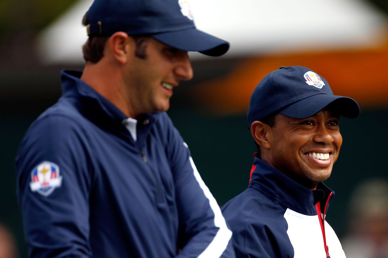 Dustin Johnson, left, and Tiger Woods of the United States laugh during a practice round Thursday.