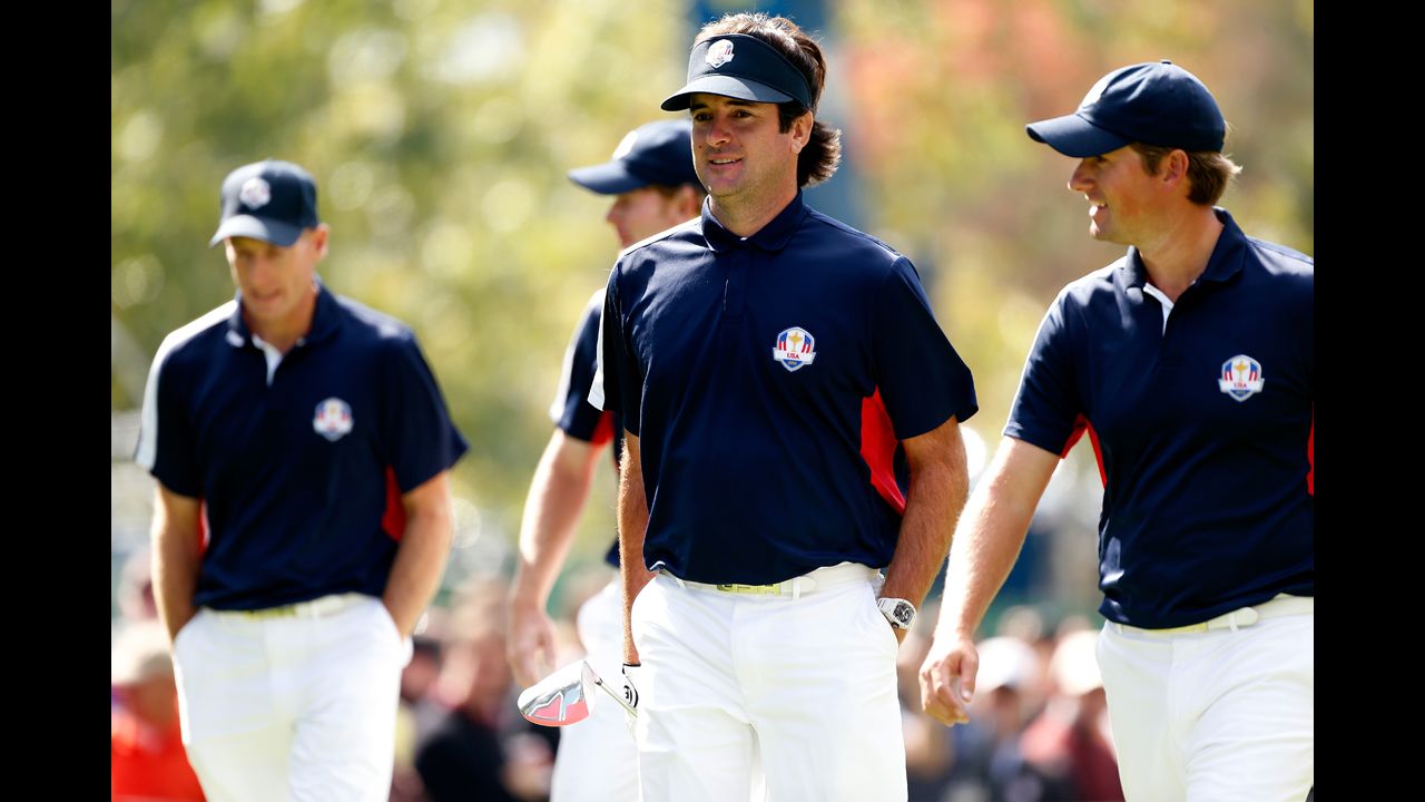 2012 Masters champion Bubba Watson, center, walks with U.S. teammate and U.S. Open winner Webb Simpson during a practice round Thursday.