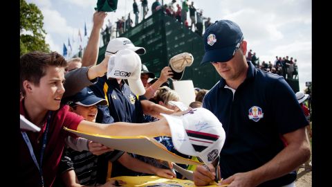 Zach Johnson signs autographs for fans after finishing the 18th hole on Thursday.