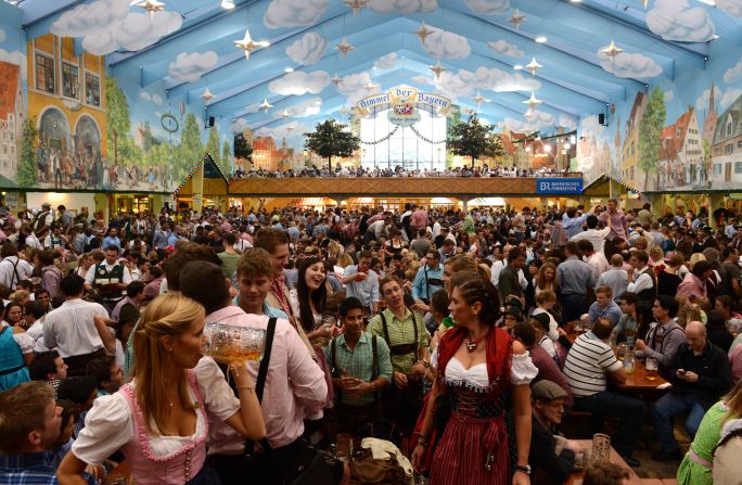 People sit on benches under a tent on Thursday, September 27.
