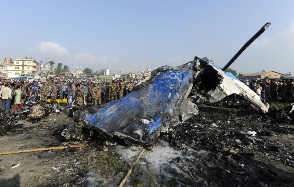 Members of the Nepalese rescue team gather around the wreckage. Officials have recovered the plane's flight data recorder, an airport official said.
