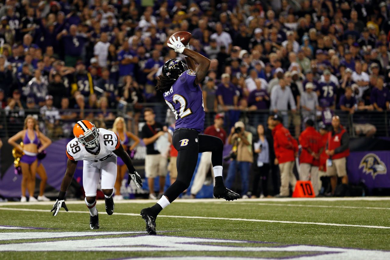 Wide receiver Torrey Smith of the Baltimore Ravens catches a touchdown pass in the second quarter against cornerback Tashaun Gipson of the Cleveland Browns Thursday.