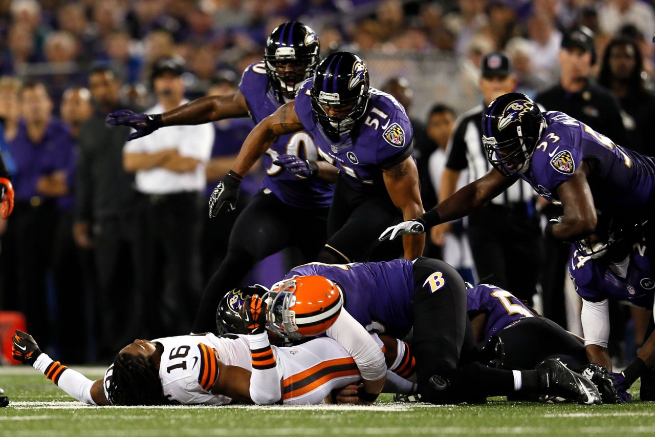 Wide receiver Joshus Cribbs of the Cleveland Browns lies unconscious on the ground after getting hit by linebacker Dannell Ellerbe in the first quarter Thursday.