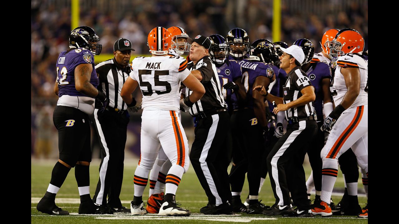 Umpire Bill Schuster, center, and referee Gene Steratore break up a fight between Cleveland Browns and Baltimore Ravens players during the game on Thursday.