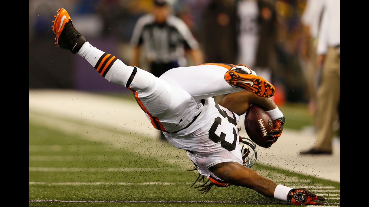 Running back Trent Richardson of the Cleveland Browns flips upside down during a run against the Baltimore Ravens.