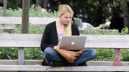 A UC Berkeley student works on her laptop while sitting on the UC Berkeley campus April 23, 2012 in Berkeley, California