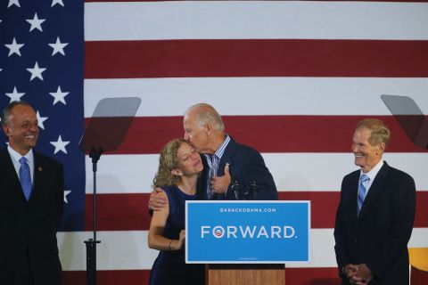 Vice President Joe Biden hugs U.S. Rep. Debbie Wasserman Schultz, chairwoman of the Democratic National Committee, as he arrives for a campaign event Friday in Boca Raton, Florida.