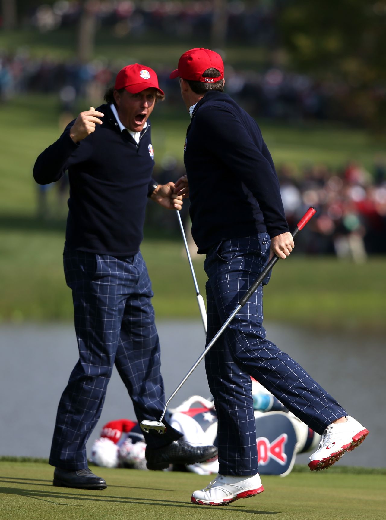 Phil Mickelson and Keegan Bradley celebrate on the 15th green after defeating Luke Donald and Sergio Garcia during the morning foursome matches on Friday.