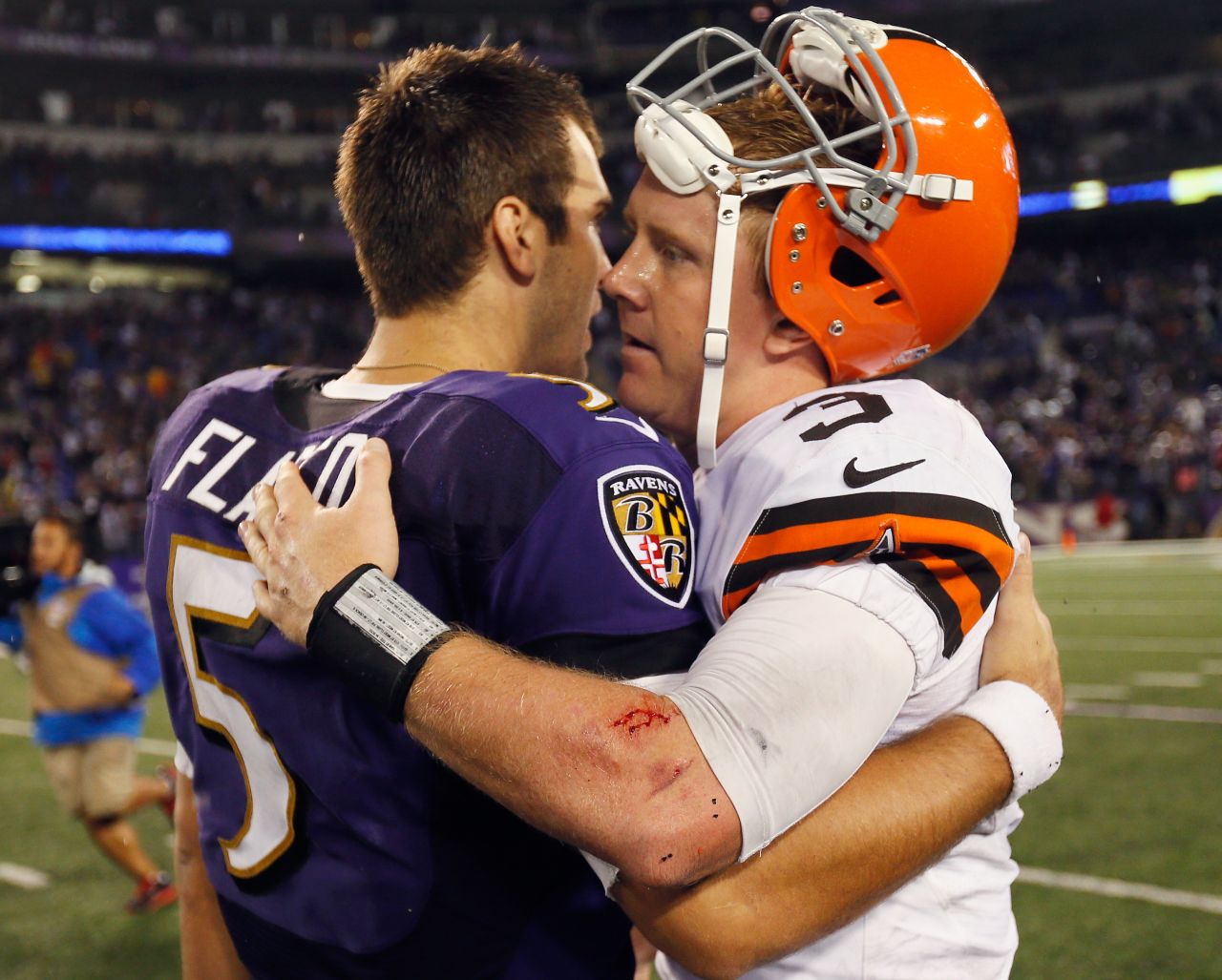 Baltimore Ravens quarterback Joe Flacco, left, hugs Cleveland quarterback Brandon Weeden following the Ravens' win on Thursday.
