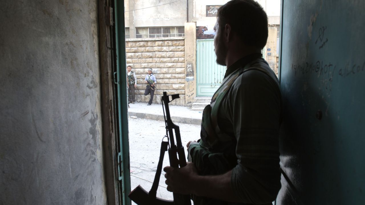 Rebel fighters hold their position 50 meters away from government troops during fighting in Aleppo on Thursday.