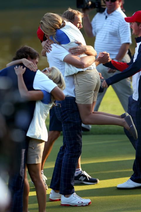 Phil Mickelson and Keegan Bradley celebrate on the 17th green with Amy Mickelson and Jillian Stacey after defeating Rory McIlroy and Graeme McDowell 2 and 1 during the afternoon four-ball matches on Friday.