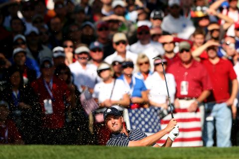 Webb Simpson of the United States plays a bunker shot on Saturday.