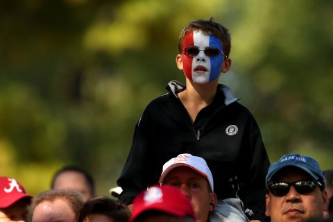 A fan of the U.S. golfers watches the action.