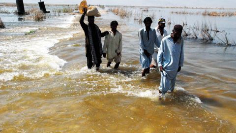 People flee flooded areas in Shahdadkot, Sindh province, Pakistan, on September 28.