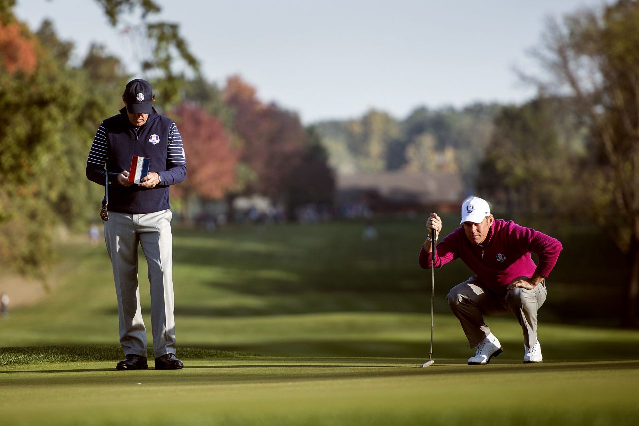 Team USA's Phil Mickelson, left, and Team Europe's Lee Westwood of England study the fifth green during a morning foursomes match on Saturday.