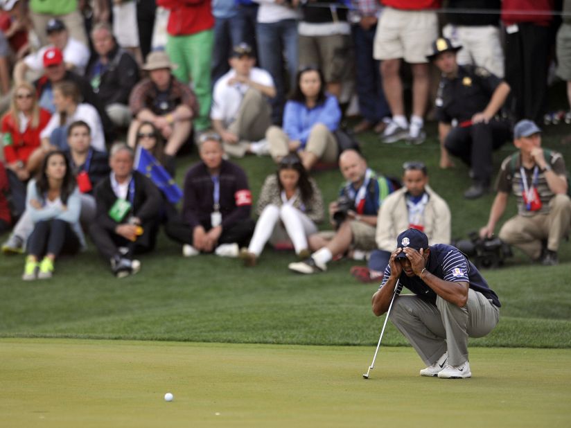 Tiger Woods of the United States scopes out a putt on the 17th hole during four-ball play Saturday.