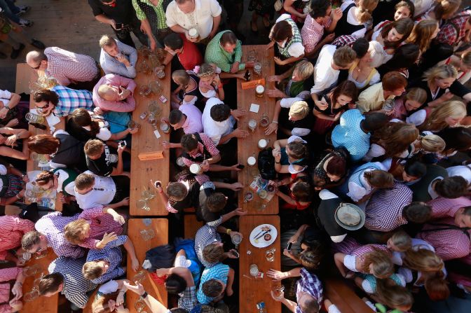 Revelers enjoy themselves as they drink beer outside the Braeurosl beer tent Friday.
