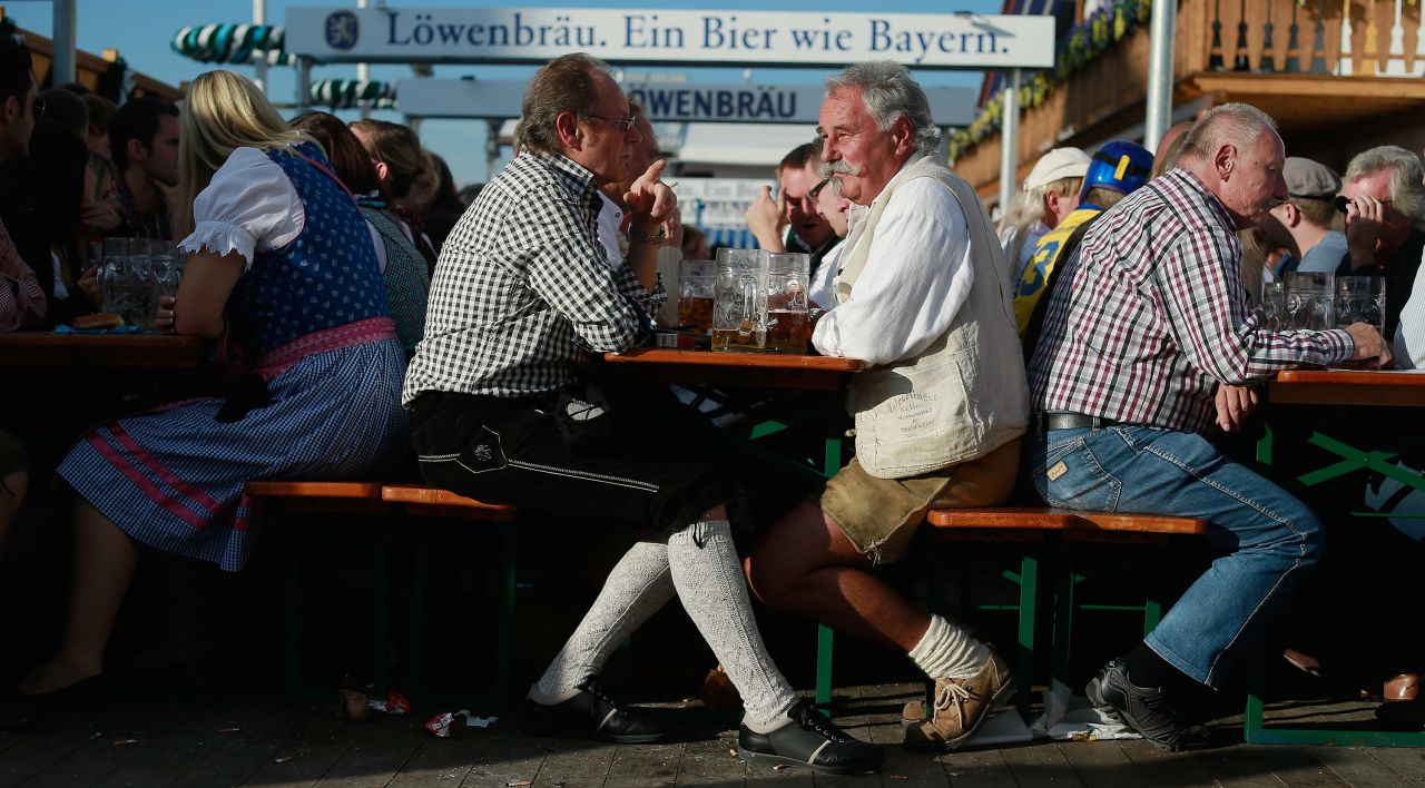 People enjoy themselves as they drink beer outside the Lowenbrau beer tent.