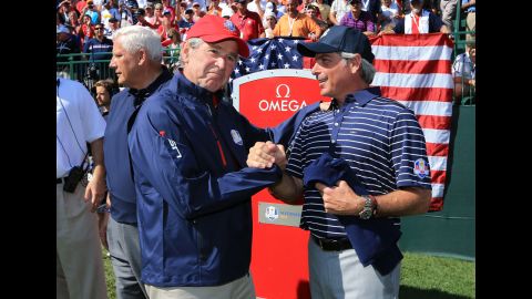 Former U.S. President George W. Bush shakes hands with Fred Couples, assistant captain of Team USA on Saturday, September 29.