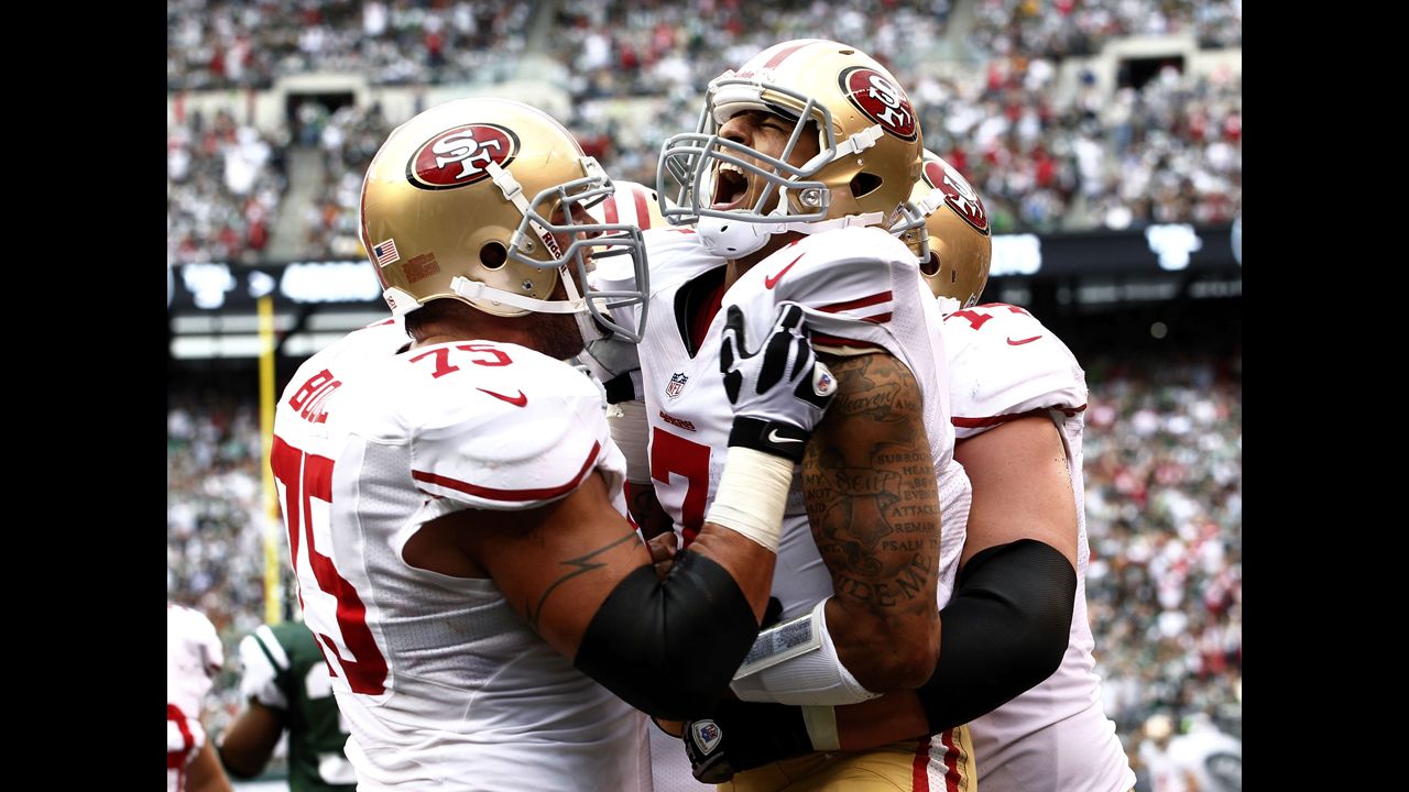 No. 7 Colin Kaepernick of the San Fransisco 49ers celebrates a touchdown with teammates Alex Boone, left, and Joe Staley during Sunday's game against the New York Jets.