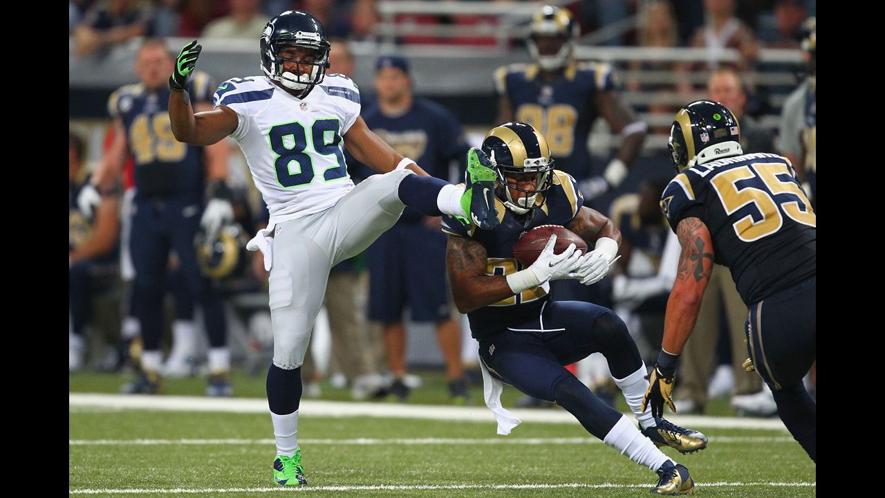 Trumaine Johnson of the St. Louis Rams intercepts a pass intended for Doug Baldwin of the Seattle Seahawks on Sunday.