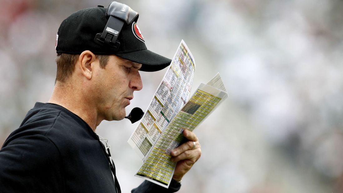 Jim Harbaugh, San Fransisco 49ers head coach, looks at notes during Sunday's game against the New York Jets.