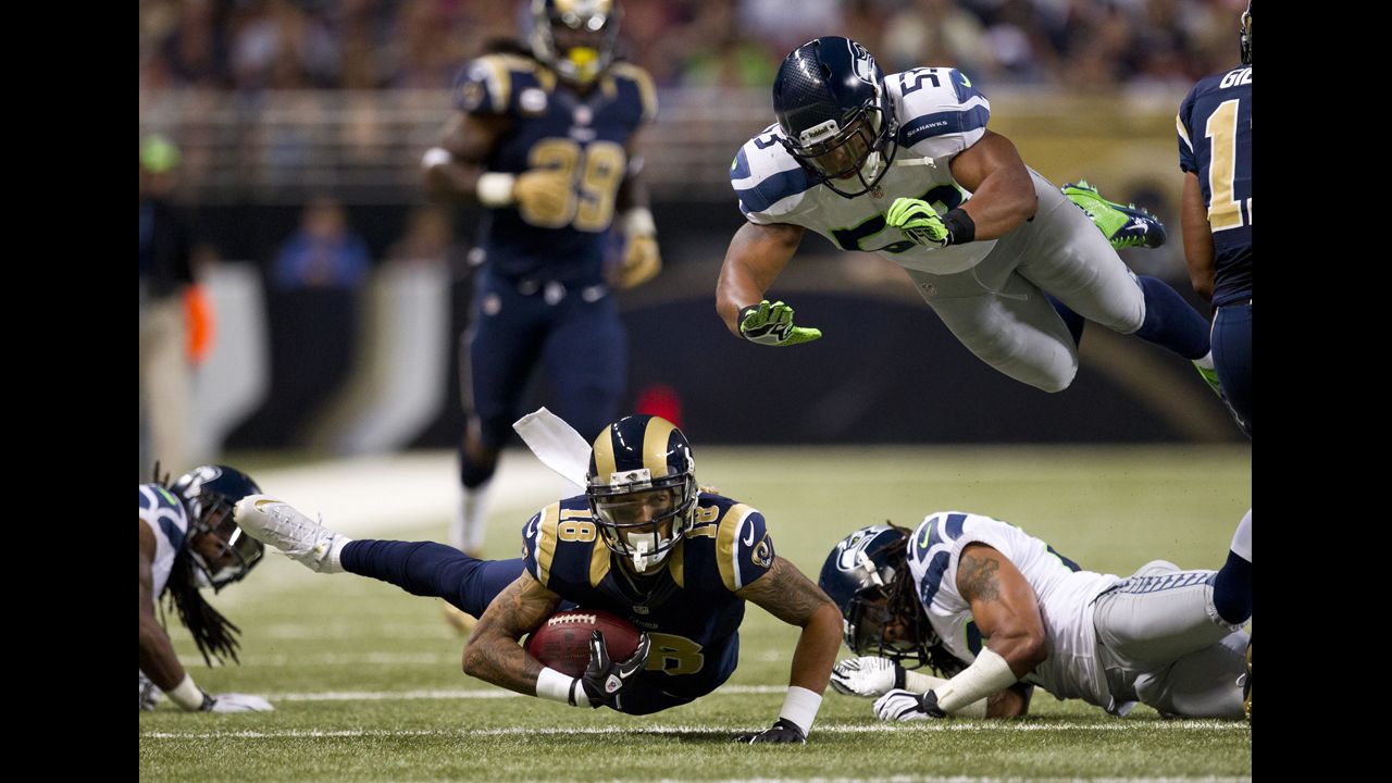 Austin Pettis of the St. Louis Rams tries to stay upright with the ball as Malcolm Smith of the Seattle Seahawks attempts to make a diving tackle on Sunday.