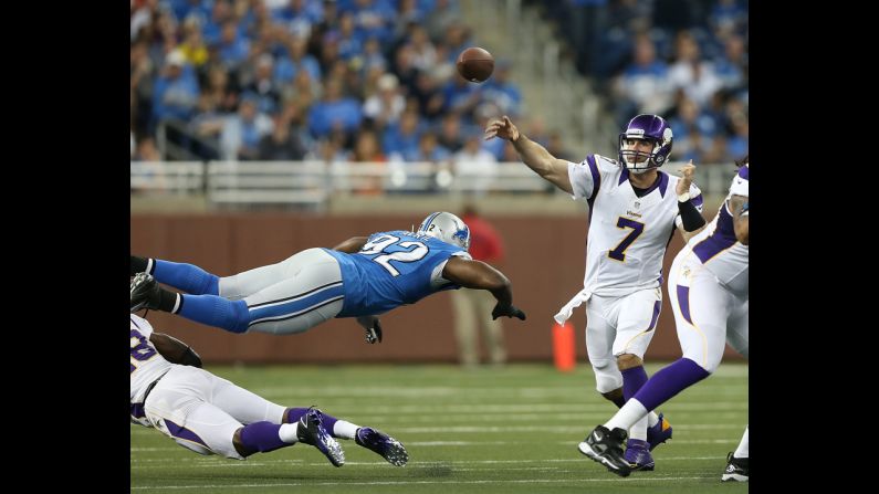 Minnesota Vikings quarterback Christian Ponder passes the football as Cliff Avril of the Detroit Lions attempts a diving tackle on Sunday at Ford Field in Detroit.