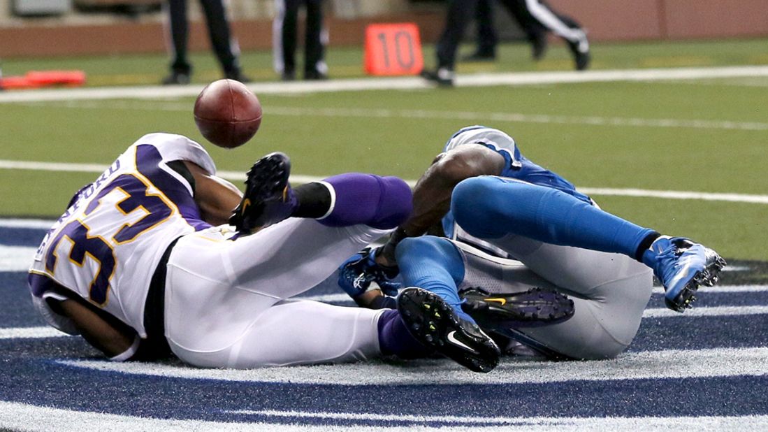 Calvin Johnson of the Detroit Lions, right, drops the ball in the end zone after a tackle by Jamarca Sanford of the Minnesota Vikings on Sunday.