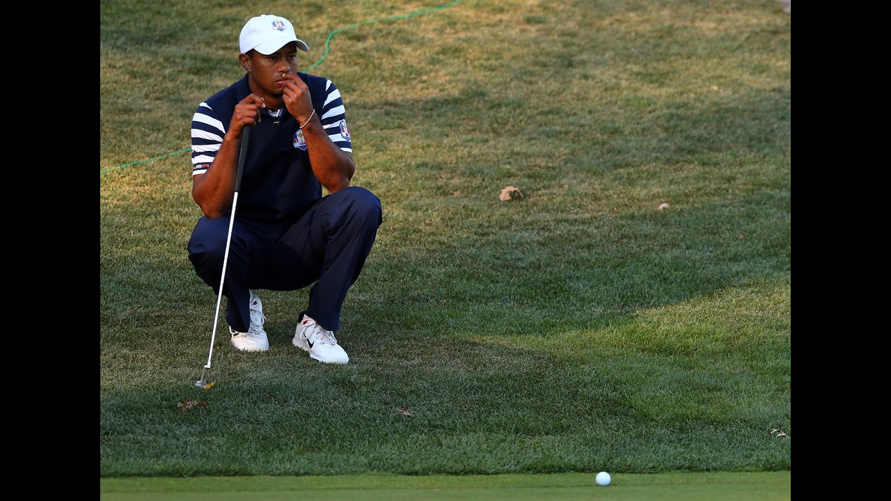 Tiger Woods waits on a hole during Sunday's singles matches.