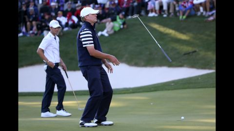 Steve Stricker of the United States reacts to a missed putt on the 17th green as Martin Kaymer of Europe looks on during Sunday's competition.
