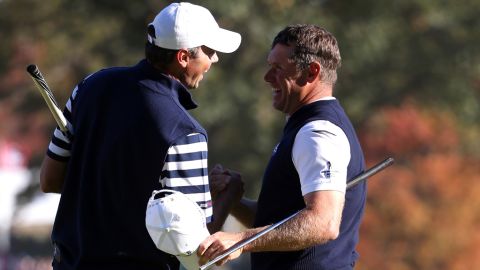 Lee Westwood of Europe, left, shakes hands with Matt Kuchar on the 16th green after defeating him Sunday.