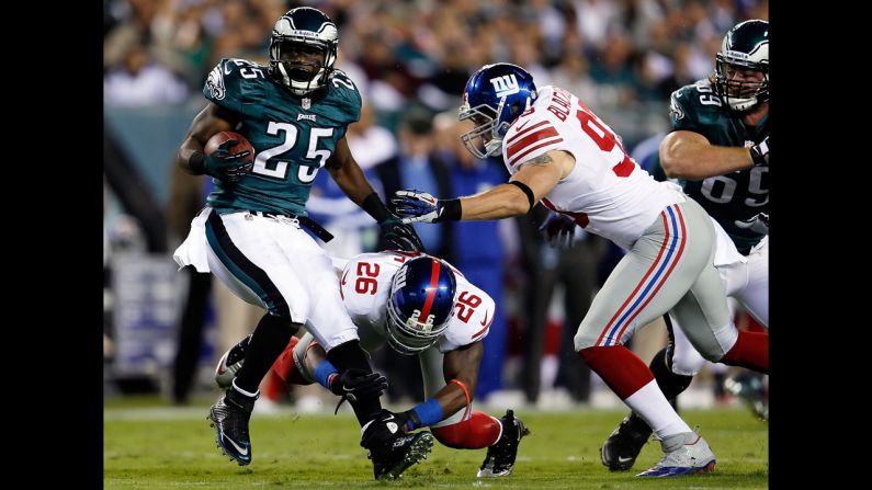 LeSean McCoy of the Philadelphia Eagles is tackled by No. 26 Antrel Rolle and No. 93 Chase Blackburn of the New York Giants on Sunday.