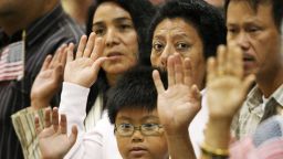 LOS ANGELES, CA - AUGUST 28: People take the oath of citizenship as 18,418 people are sworn in as US citizens during naturalization ceremonies at the Los Angeles Convention Center on August 28, 2008 in Los Angeles, California. Immigrants, especially Latinos, which now make up 15 percent of the US population, play an increasingly important role in US politics. Democratic presidential candidate Barack Obama (D-IL), who could benefit from a strong Hispanic following of former presidential hopeful Sen. Hillary Clinton (D-NY), who now campaigns for him, has set aside $20 million for Latino outreach. Republican rival John McCain has also stepped up efforts to attract Latinos, focusing particularly on those in the military. The US Department of Homeland Security reports that citizenship applications have jumped by more than 100 percent since 2006, a surge in naturalization that is expected to add to the 17 million existing eligible Latino voters nationwide and lead to an anticipated record of 9.2 million Latinos voting in the November presidential election. Issues of interest to Latinos include the slumping economy, employment, health care, housing, and immigration reform. (Photo by David McNew/Getty Images) 