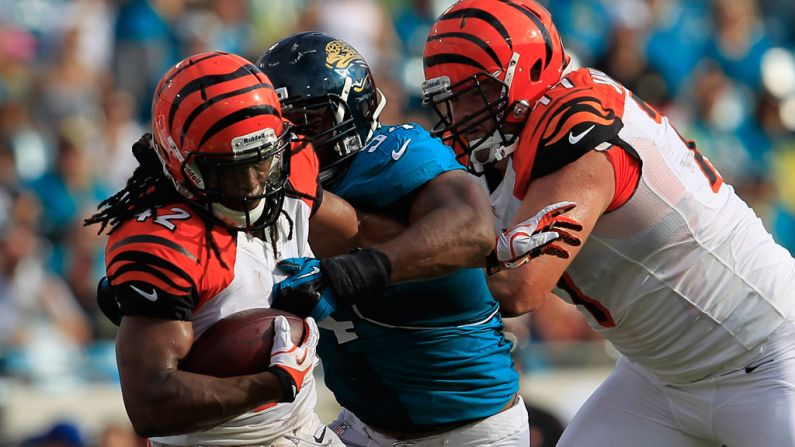 BenJarvus Green-Ellis of the Cincinnati Bengals is tackled by Jeremy Mincey of the Jacksonville Jaguars on Sunday.