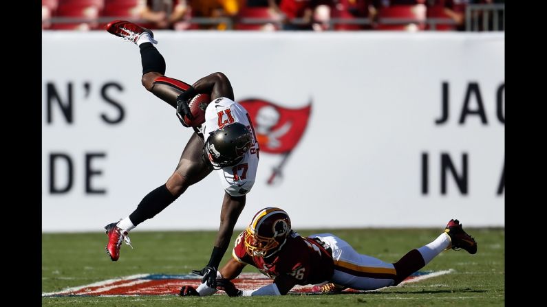 Josh Wilson of the Washington Redskins hits receiver Arrelious Benn of the Tampa Bay Buccaneers on Sunday.