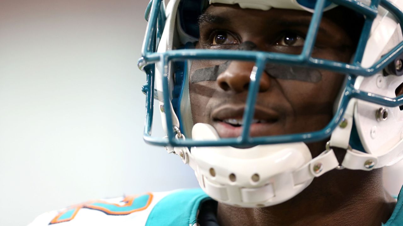 Miami Dolphins running back Reggie Bush watches from the sidelines on Sunday.