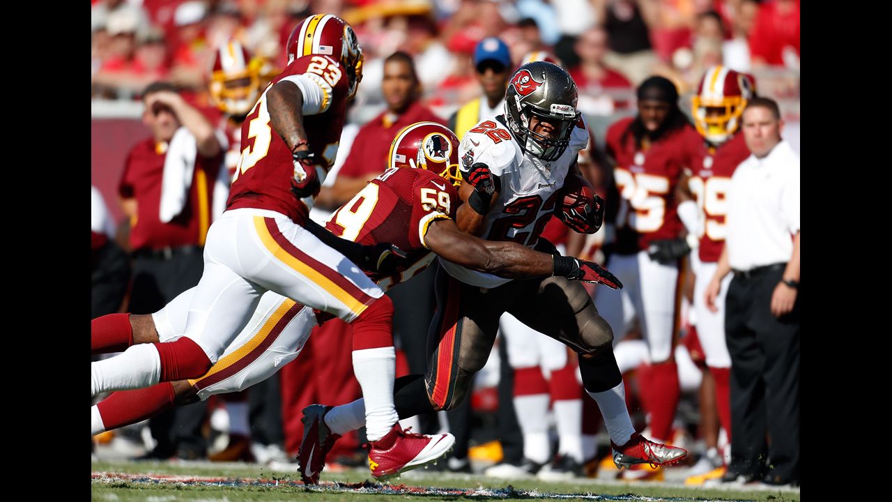 Doug Martin of the Tampa Bay Buccaneers is tackled Sunday by London Fletcher of the Washington Redskins.